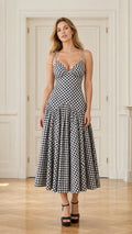 Front view of model wearing black and white gingham midi dress