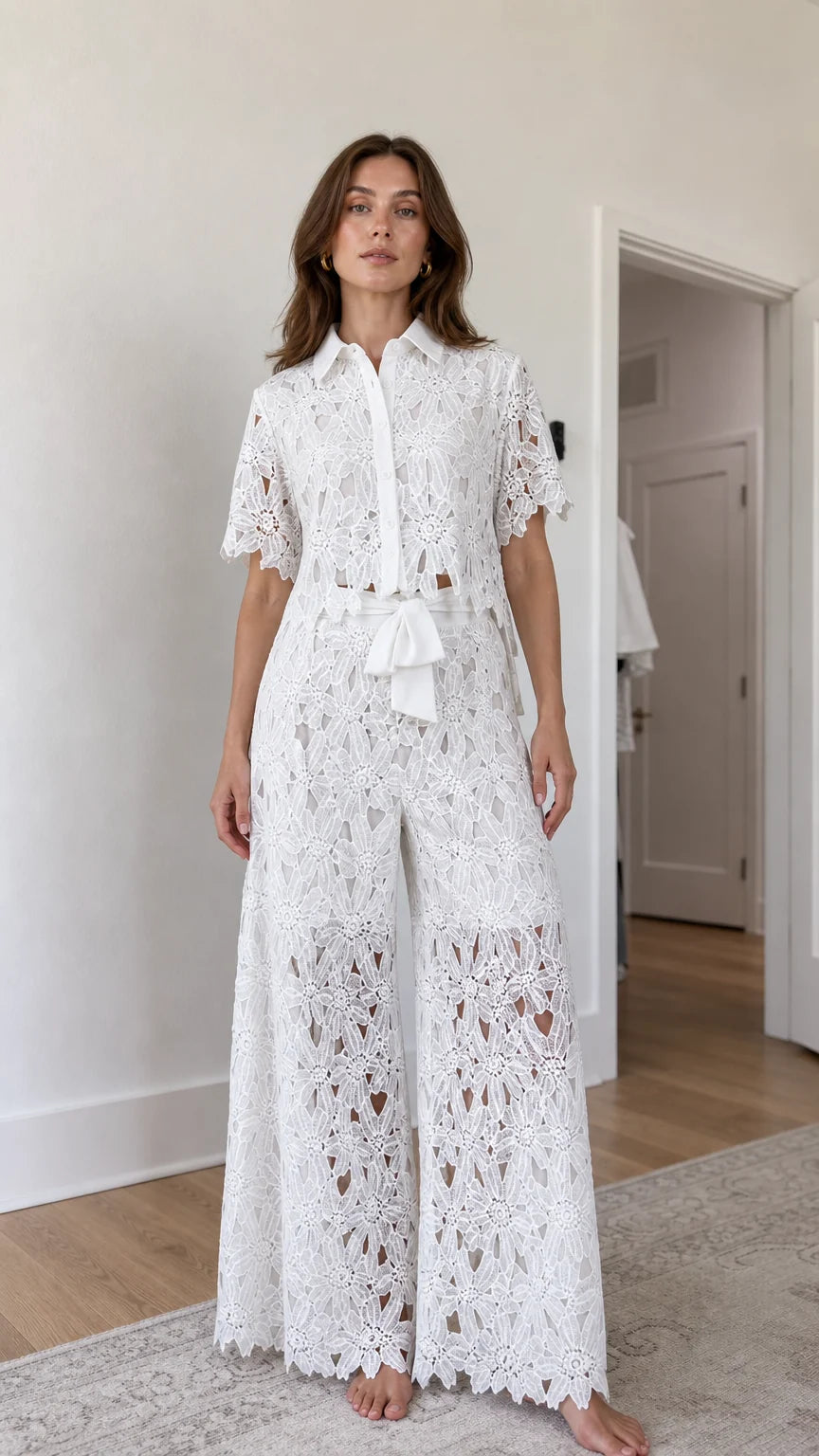 Front view of woman wearing white floral lace shirt and wide-leg pants set