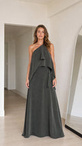 Front view of model wearing charcoal grey one-shoulder tiered draped maxi dress
