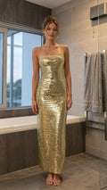 Front view of model wearing gold sequin maxi dress