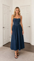 Front view of woman wearing blue denim midi dress