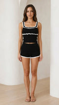 Front view of model wearing black contrast ruffle knit lounge set