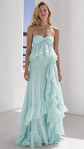 Front view of model wearing mint green strapless ruffled maxi dress