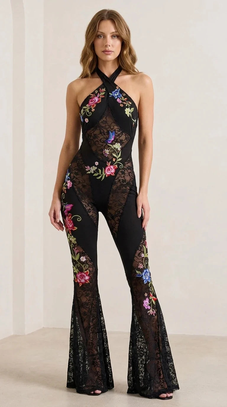 Front view of woman wearing black halter neck floral embroidered lace jumpsuit
