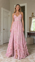 Front view of model wearing pink floral pearl-trimmed halter maxi dress with high slit
