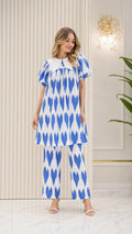 Front view of model wearing Bright Blue geometric print tunic and pants two-piece set