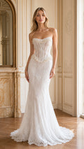 Front full-length view of model wearing white strapless pearl beaded corset lace mermaid gown