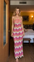 Model wearing pink multi chevron knit halter maxi dress from the front