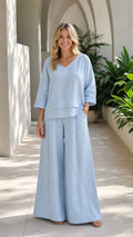 Front view of woman wearing light blue two-piece wide-leg set