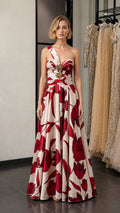 Front view of model wearing red and cream floral one-shoulder evening gown