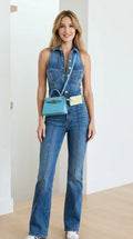 Front view of model wearing blue denim flare jumpsuit