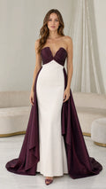 Front view of burgundy and white strapless evening dress with over-skirt train
