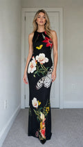 Model wearing black floral butterfly print sleeveless maxi dress from the front