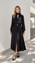 Model wearing black mock neck belted midi dress from the front