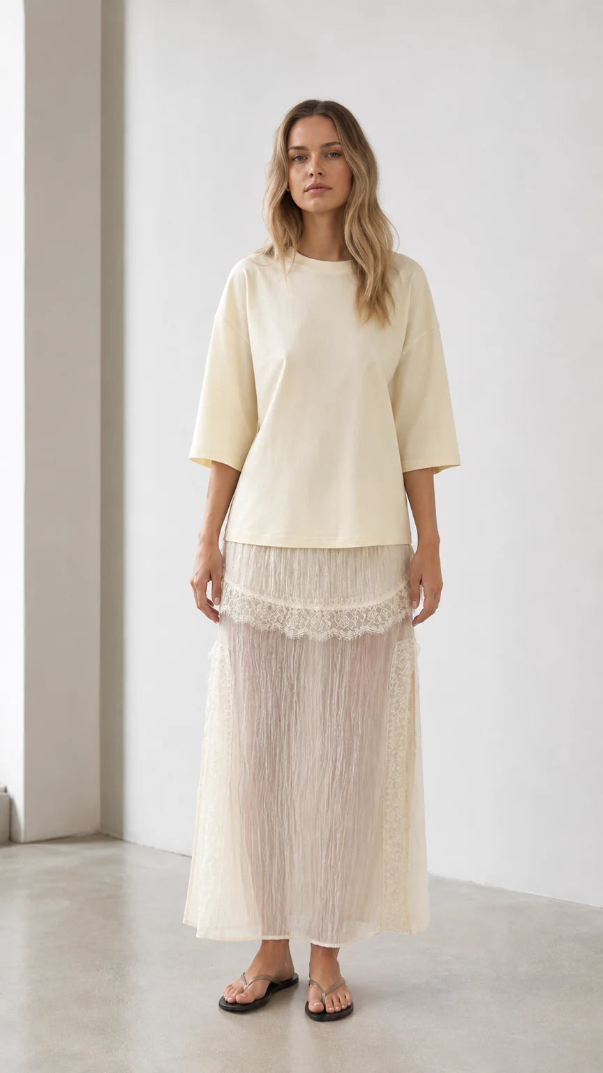 Front view of woman wearing cream relaxed tee and matching mesh maxi skirt