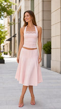 Model wearing the pink halter top and midi skirt set, front view