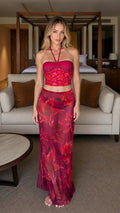 Front view of model wearing Fuchsia floral halter top and maxi skirt set