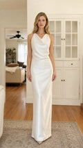Front view of model wearing white satin cowl neck maxi dress