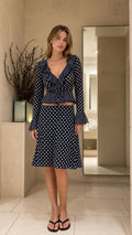 Front view of model wearing Navy Blue polka dot two piece set