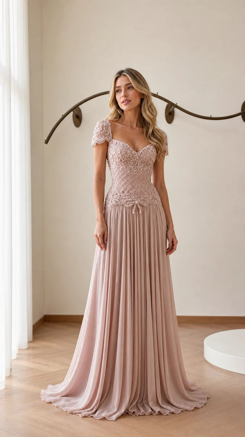 Front view of model wearing blush pink beaded chiffon evening gown