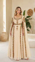 Front view of model wearing champagne embellished cape maxi evening gown