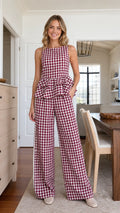 Front view of model wearing burgundy gingham peplum top and wide leg pants set