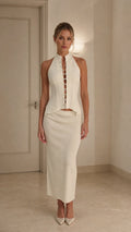 Model wearing ivory crystal embellished halter top and midi skirt set from front