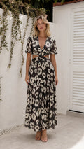 Front view of model wearing black floral cutout maxi dress