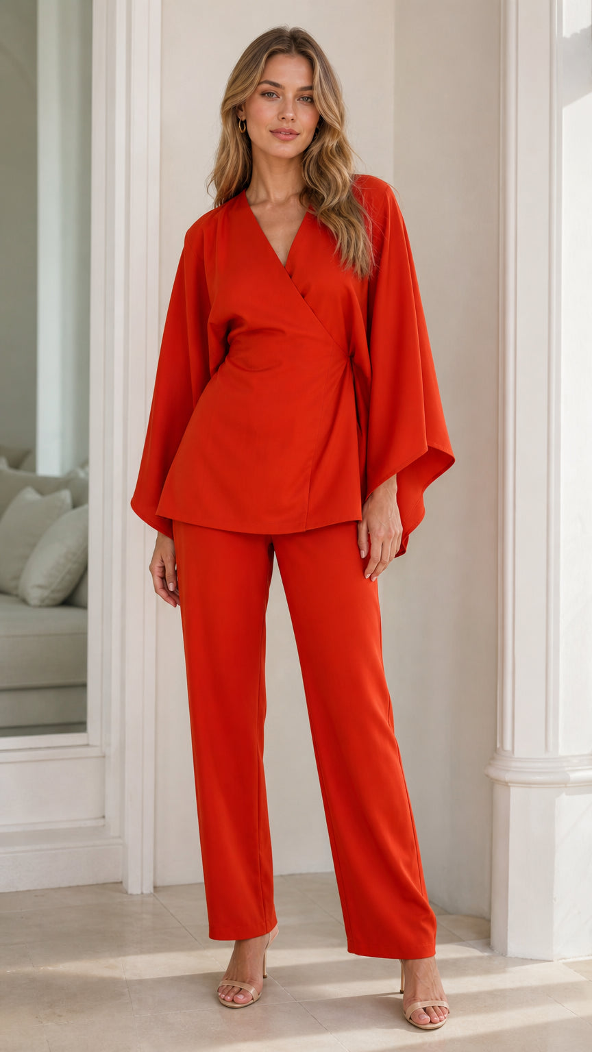 Front view of model wearing burnt orange wrap top and straight-leg pant set