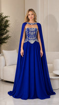 Front view of royal blue embellished corset evening gown with attached cape