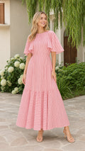 Front view of model wearing pink striped flutter sleeve tiered maxi dress