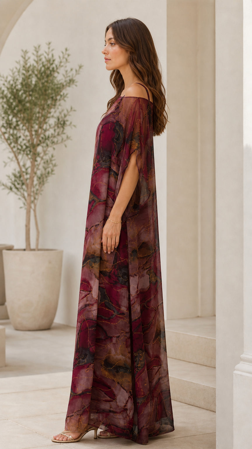 Side profile view of burgundy printed sheer overlay kaftan maxi dress