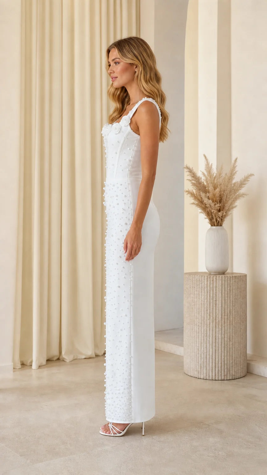 Side profile of model in white pearl embellished maxi dress