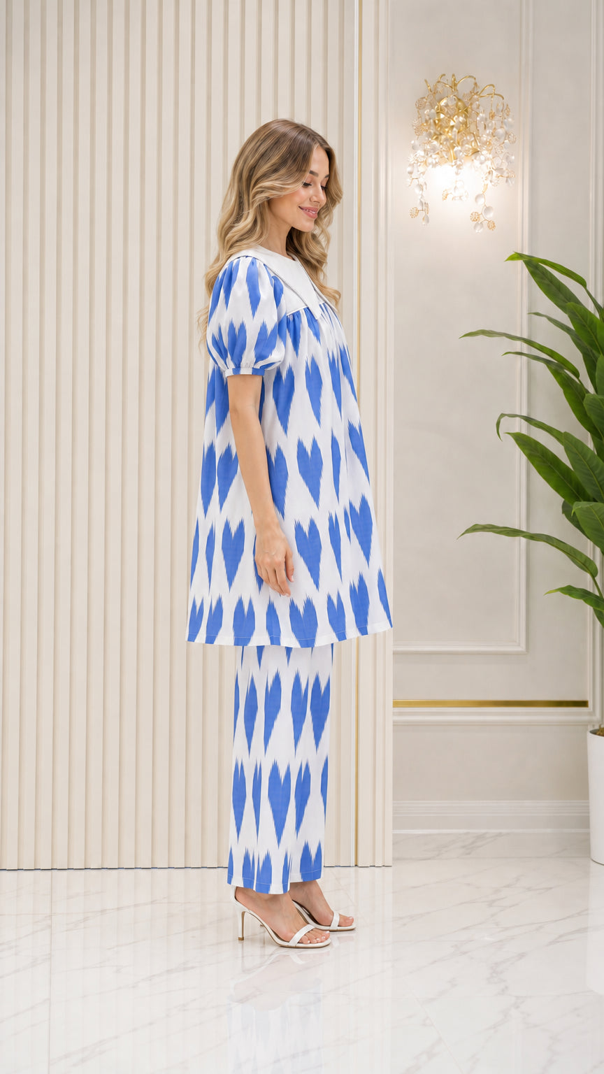 Side profile view of model wearing Bright Blue tunic set with statement collar