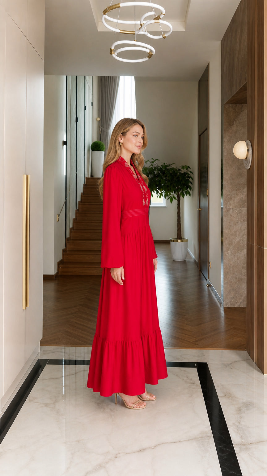 Side profile view of woman wearing red embroidered maxi dress