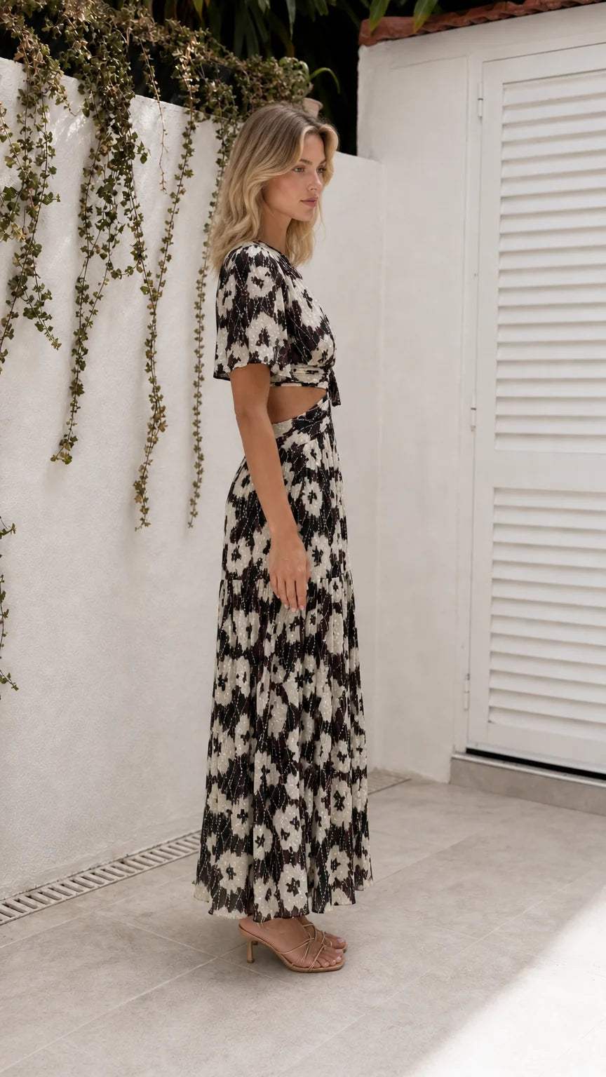 Side view of model wearing black floral cutout maxi dress