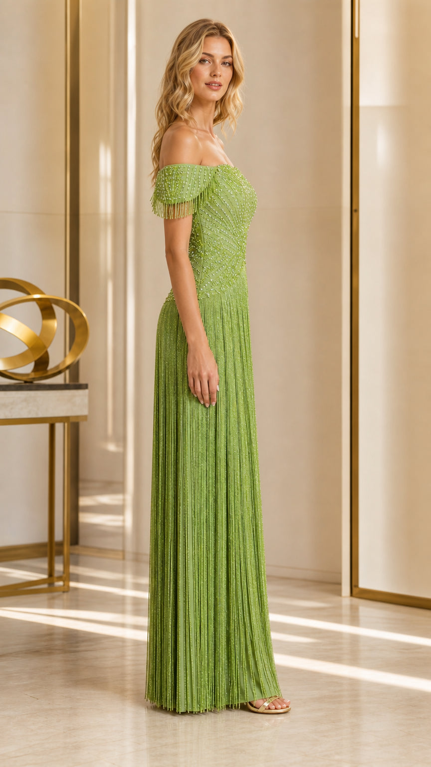 Side profile view of olive green off-the-shoulder fringe evening gown