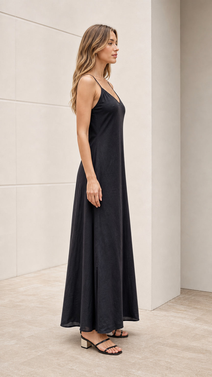 Model wearing black slip dress side view