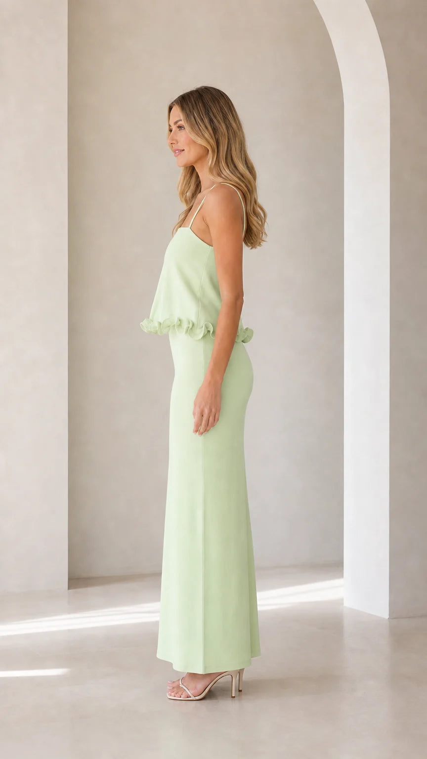 Side profile view of model in sage green maxi dress