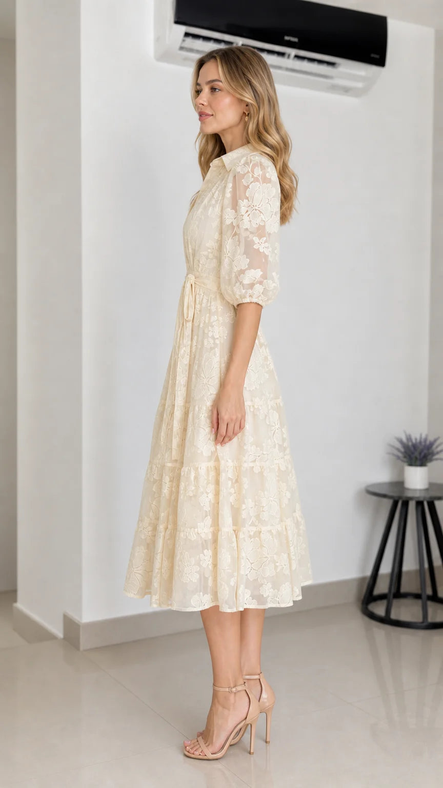 Side profile view of cream midi dress on model