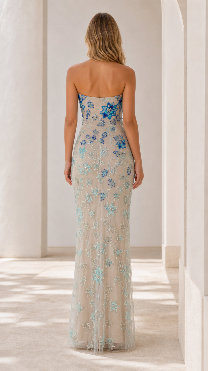 Back view of champagne strapless column gown with blue beading