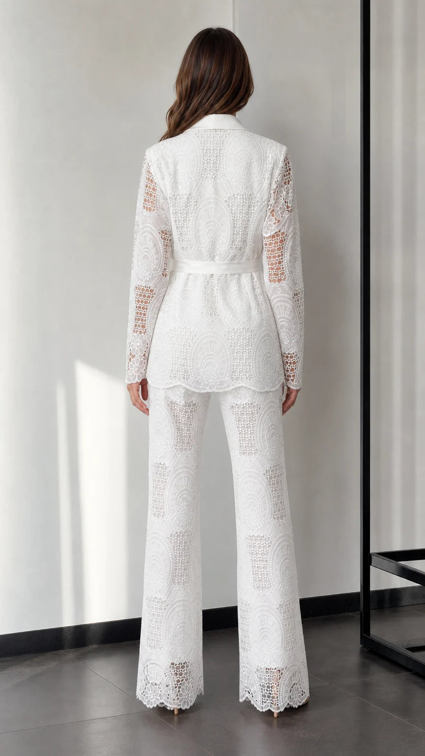 Back view of woman wearing white lace two-piece suit