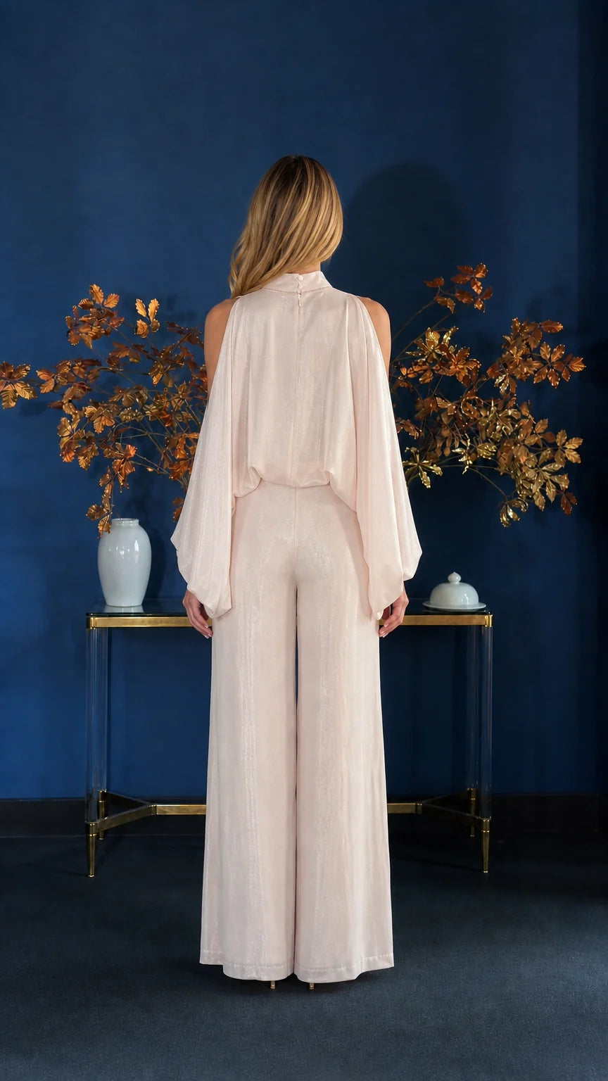 Back view of champagne jumpsuit with cape overlay