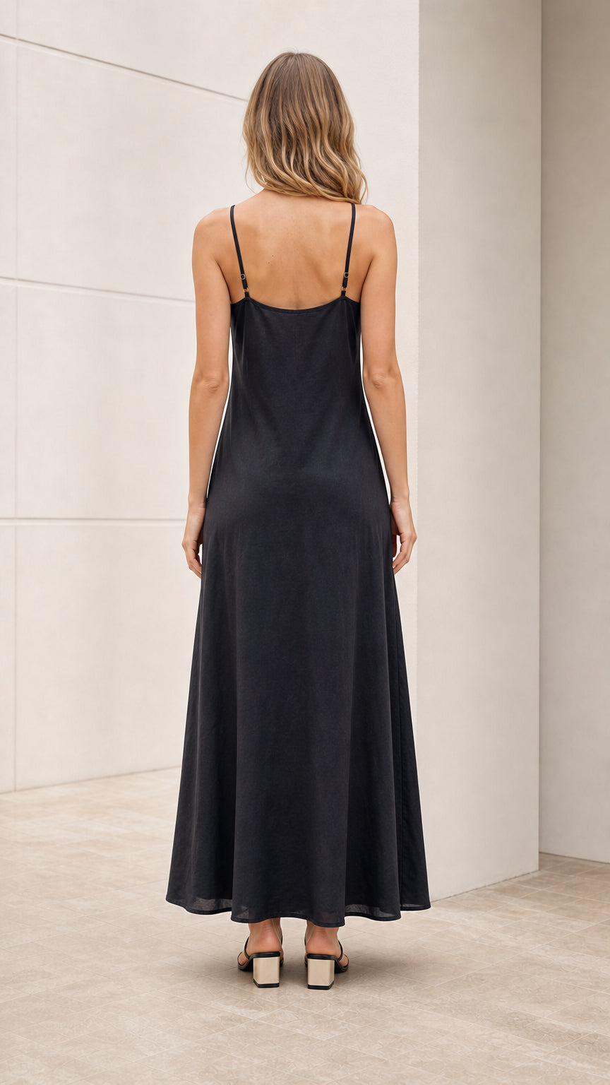 Model wearing black slip dress back view