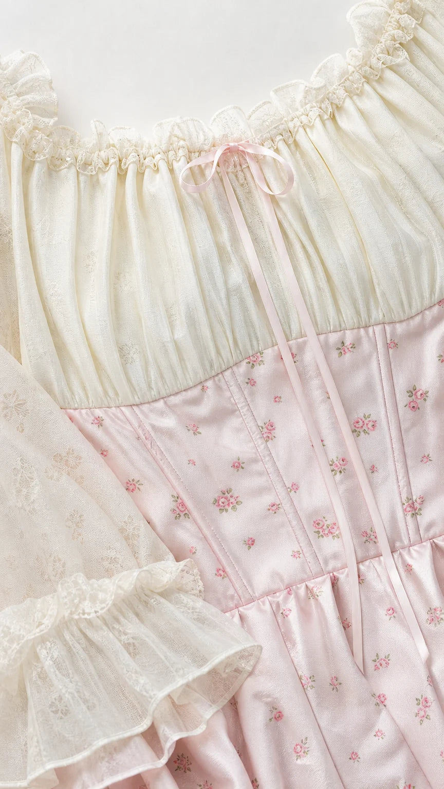 Close-up detail of neckline, bodice, and sleeves of pink dress