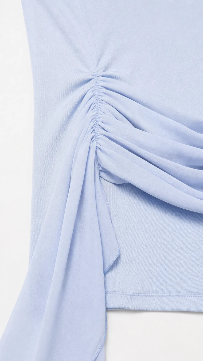 Close-up detail of hip ruching and fabric sash