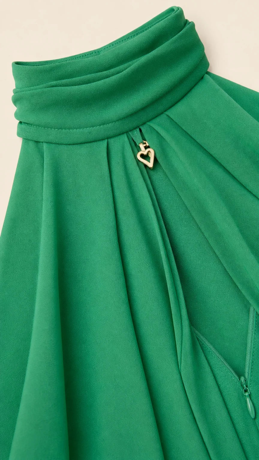 Close up of neckline detail with gold heart charm on green dress
