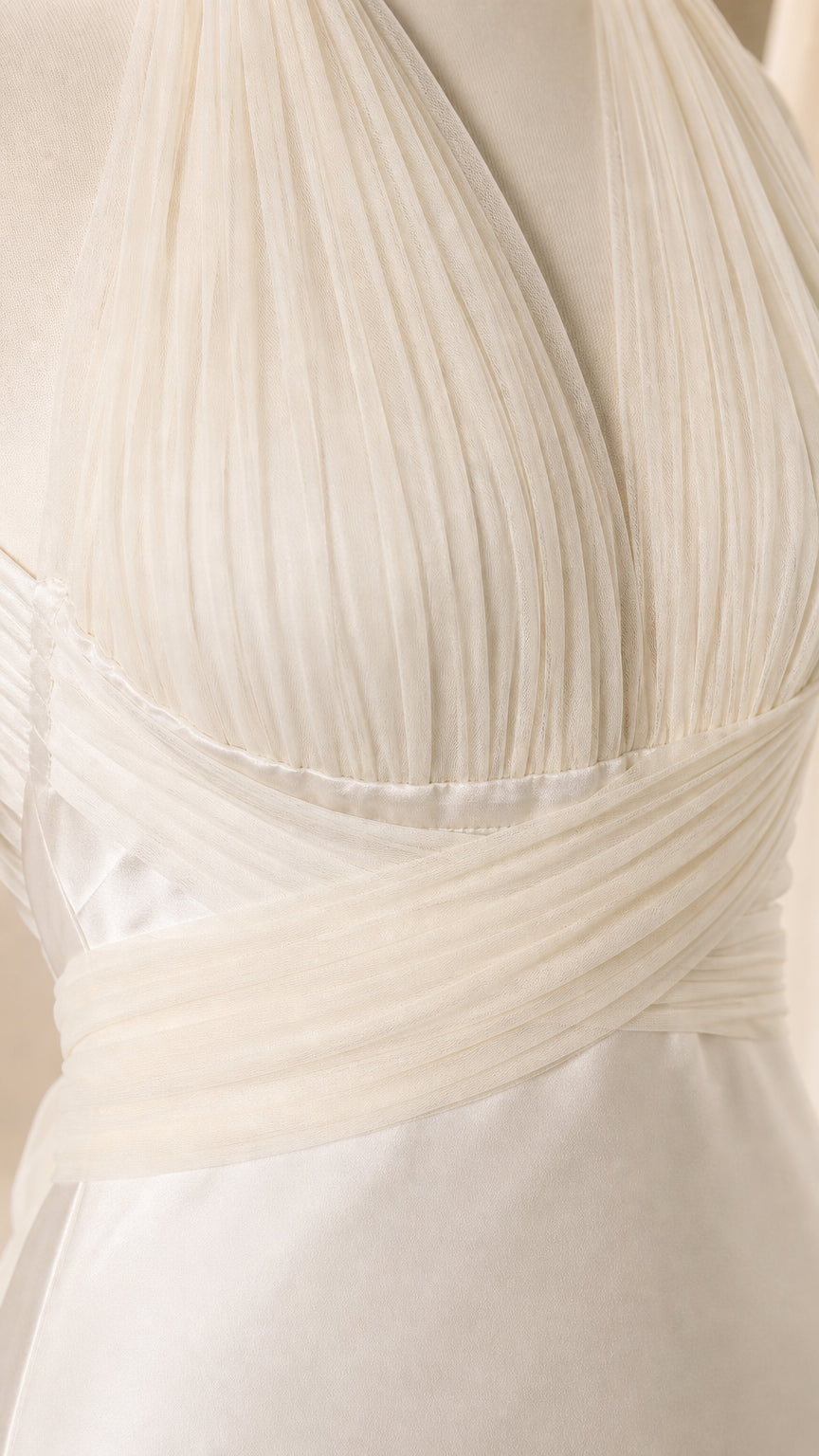 Close-up detail of pleated chiffon crossover halter bodice