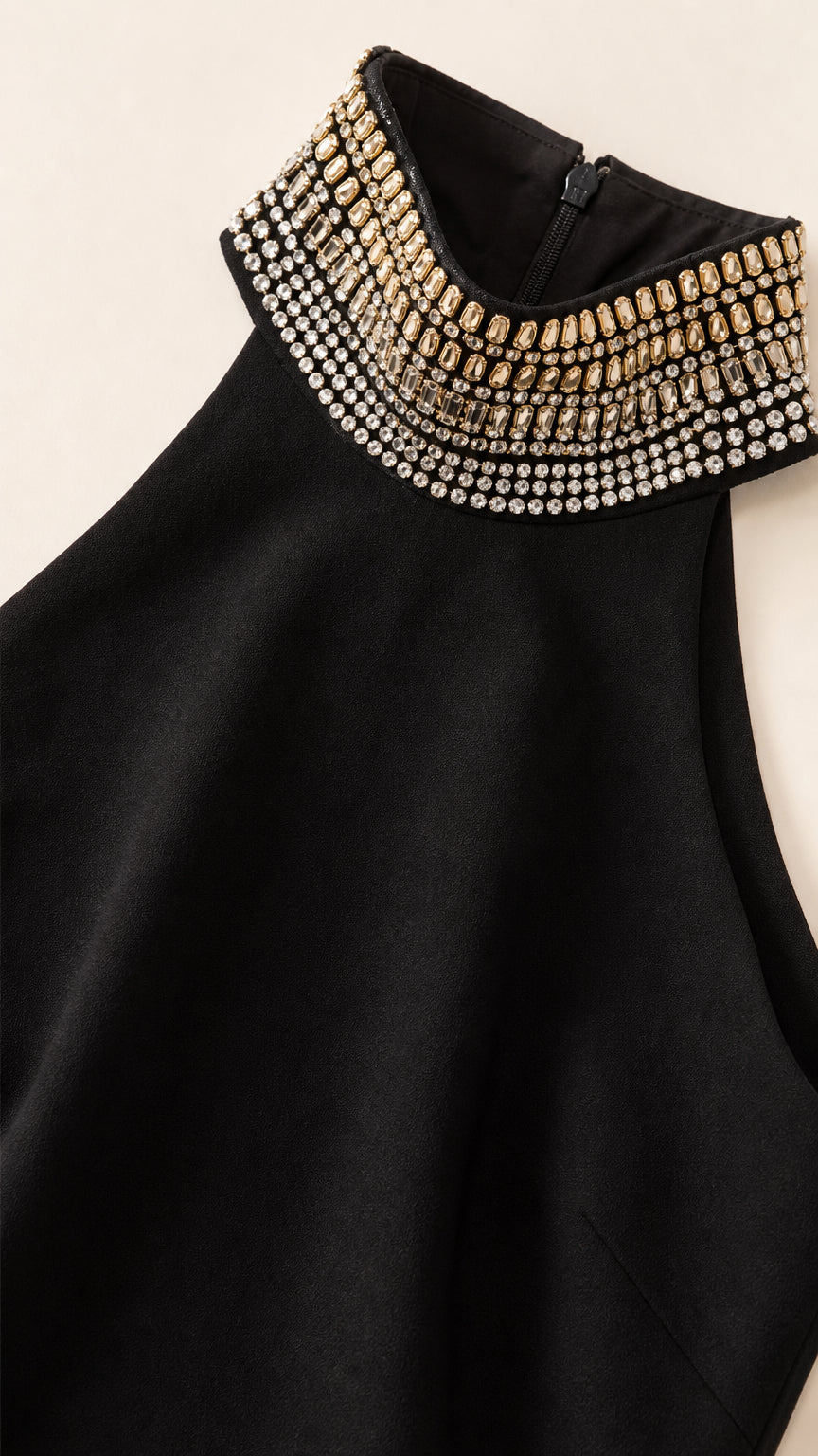 Close-up of sparkling crystal and rhinestone embellishments on black halter collar