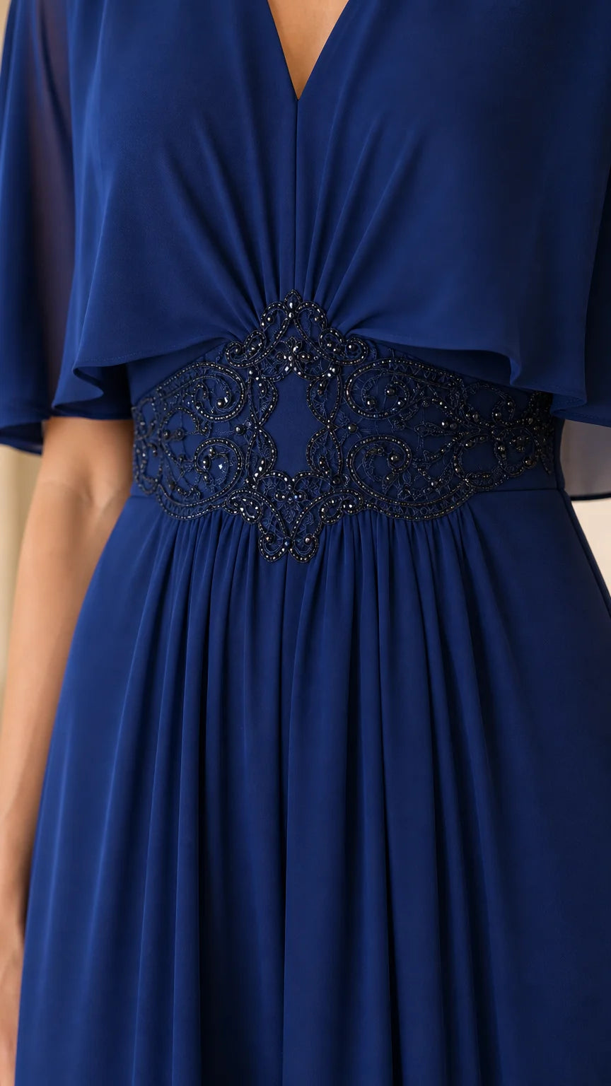 Close-up of beaded waist detail on royal blue evening dress